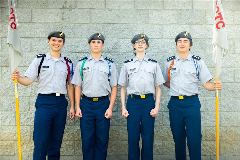 Four JROTC members smile